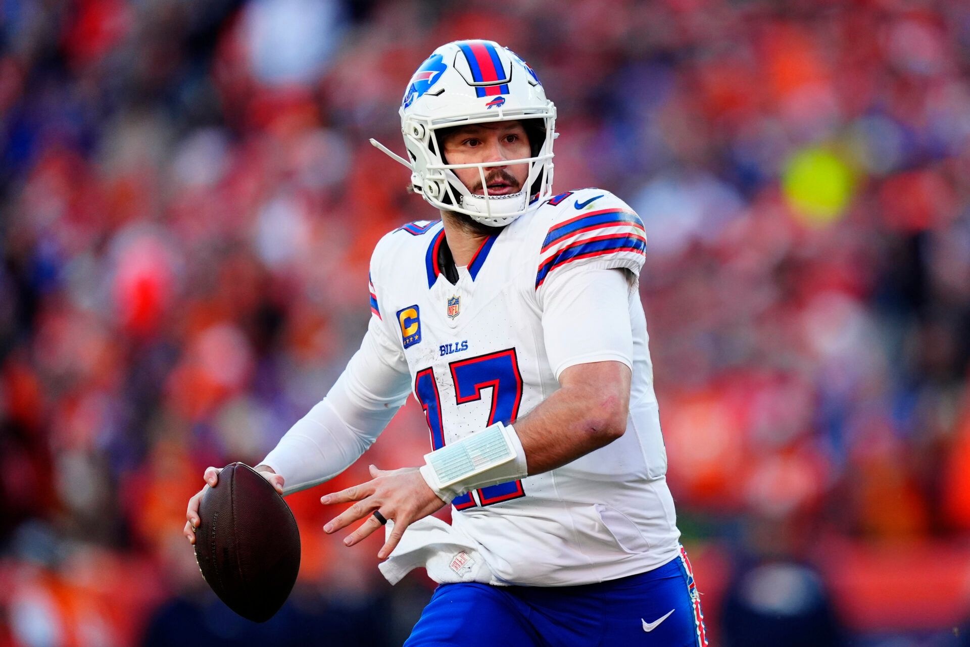 Buffalo Bills quarterback Josh Allen (17) rolls out during the second quarter of an AFC Divisional Round playoff game against the Denver Broncos at Empower Field at Mile High.