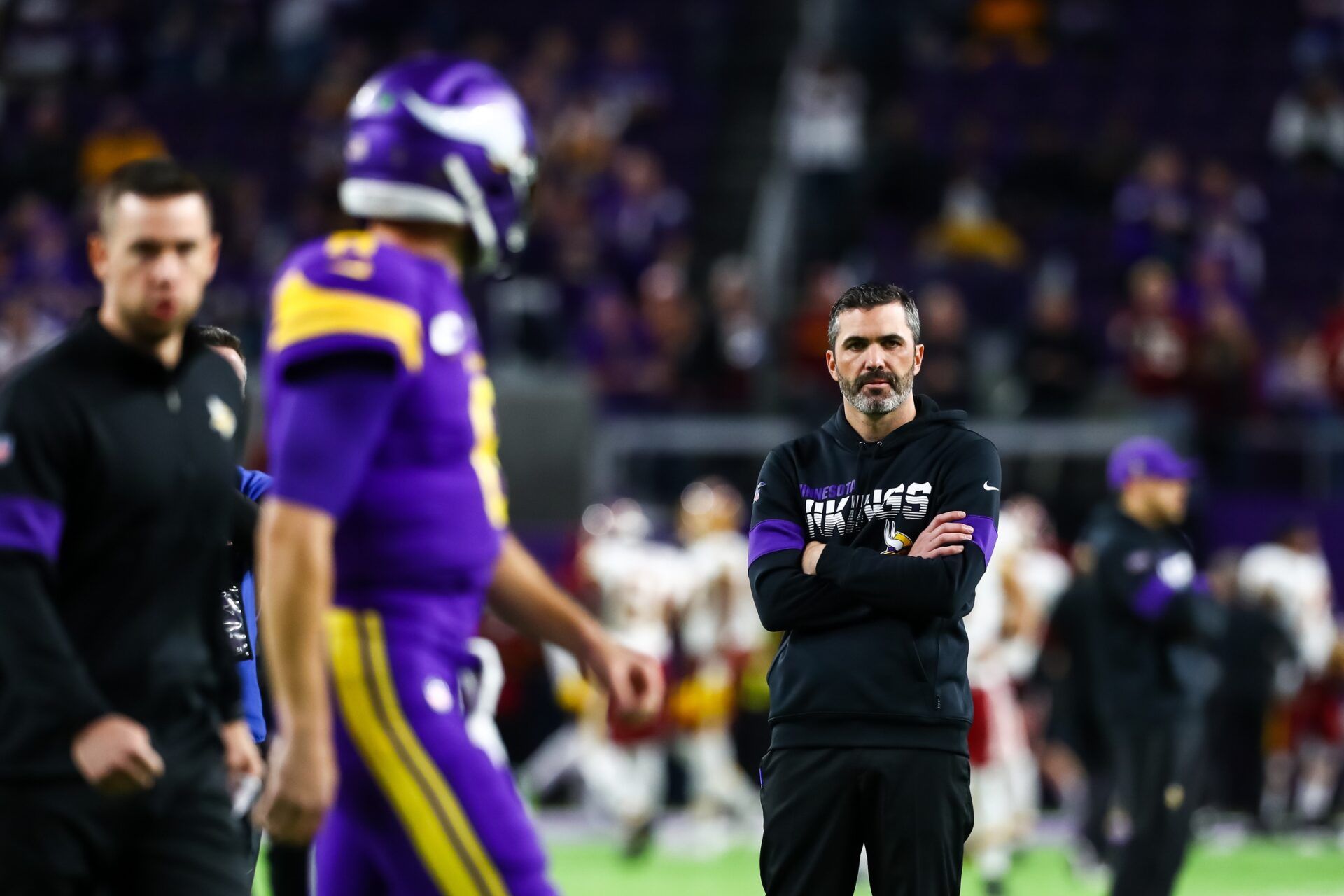 Minnesota Vikings quarterback Kirk Cousins (8) participates in warm ups while offensive coordinator Kevin Stefanski looks on before the start of a game against the Washington Redskins at U.S. Bank Stadium.
