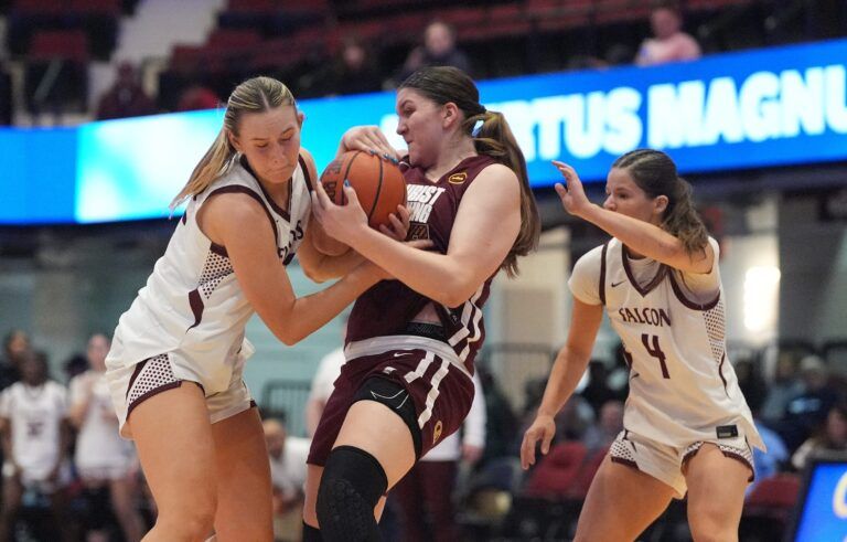 Albertus' Julia Scott (22) and Christ the King's Olivia Vukosa (25) fight for possession during the 8th annual Slam Dunk Showcase at the Westchester County Center in White Plains on Saturday, January 3, 2026.