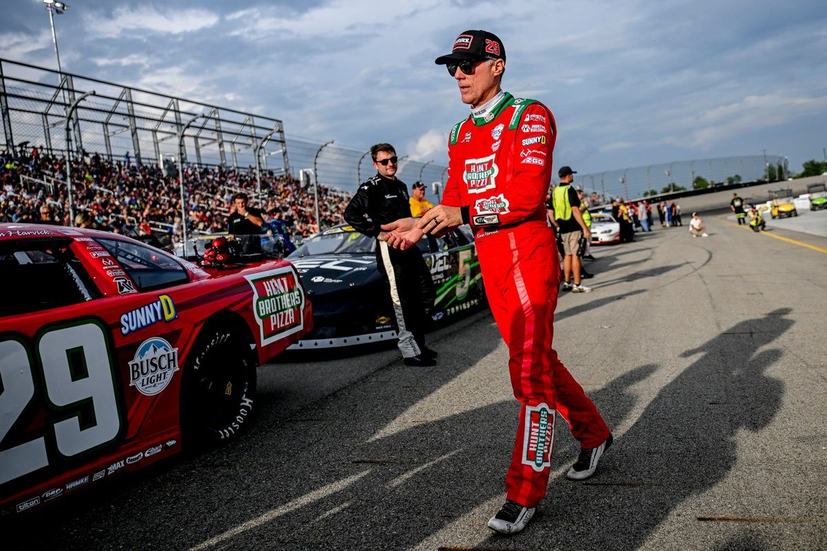 Former NASCAR Cup Series champion Kevin Harvick walks to his car before the 13th annual Masters of the Pros 200 race on Wednesday, July 16, 2025, at the Owosso Speedway. Harvick and his 13-year-old son Keelan competed against each other in the race.