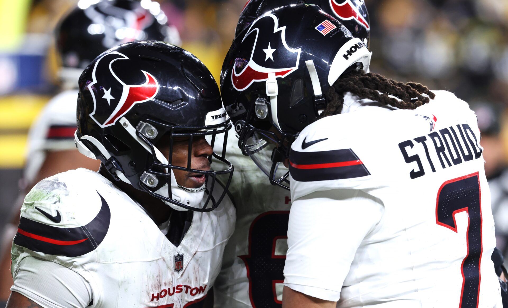 Houston Texans running back Woody Marks (27) and quarterback C.J. Stroud (7) celebrate after a touchdown during the second half of an AFC Wild Card Round game against the Pittsburgh Steelers at Acrisure Stadium.