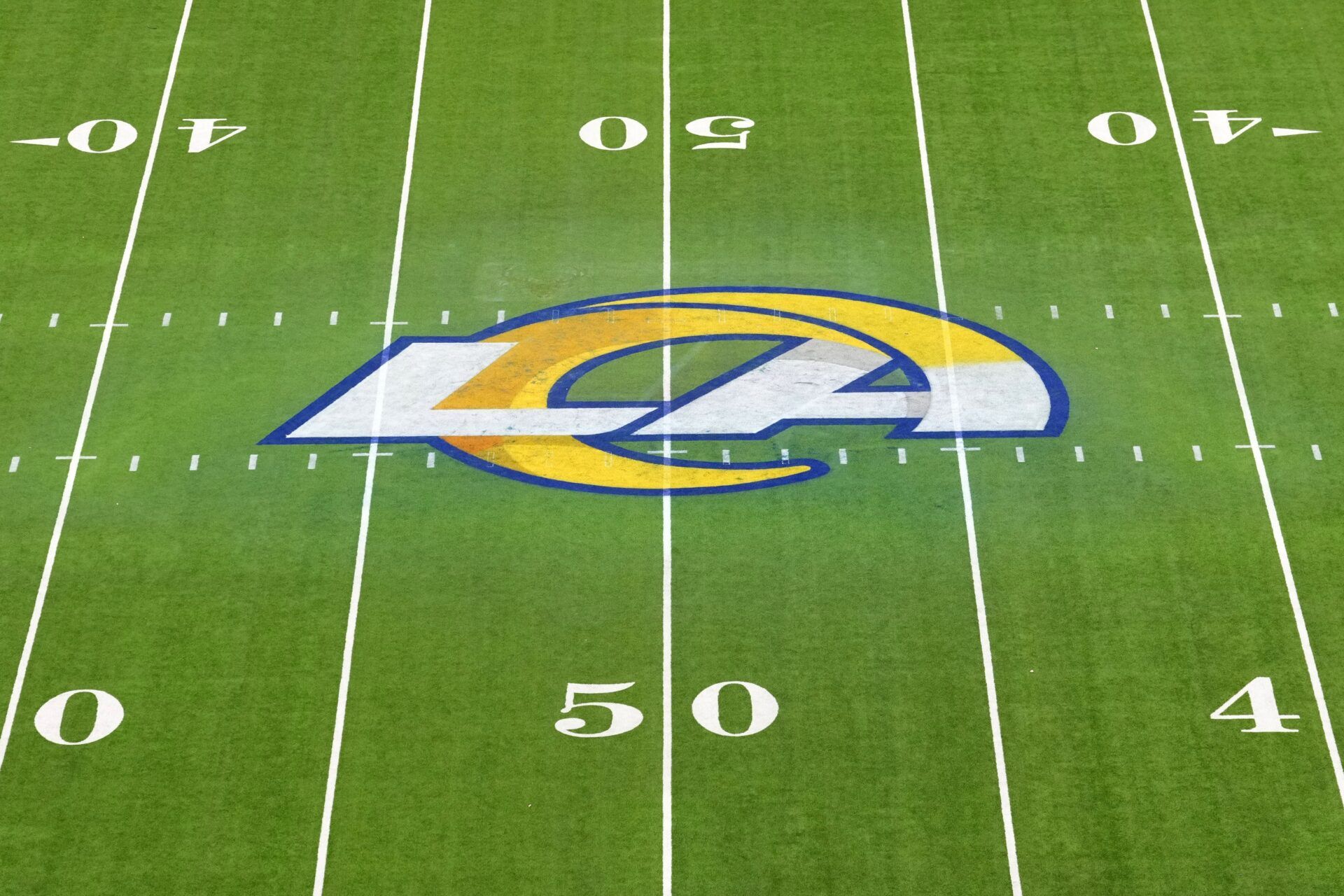 The Los Angeles Rams logo at midfield at SoFi Stadium.