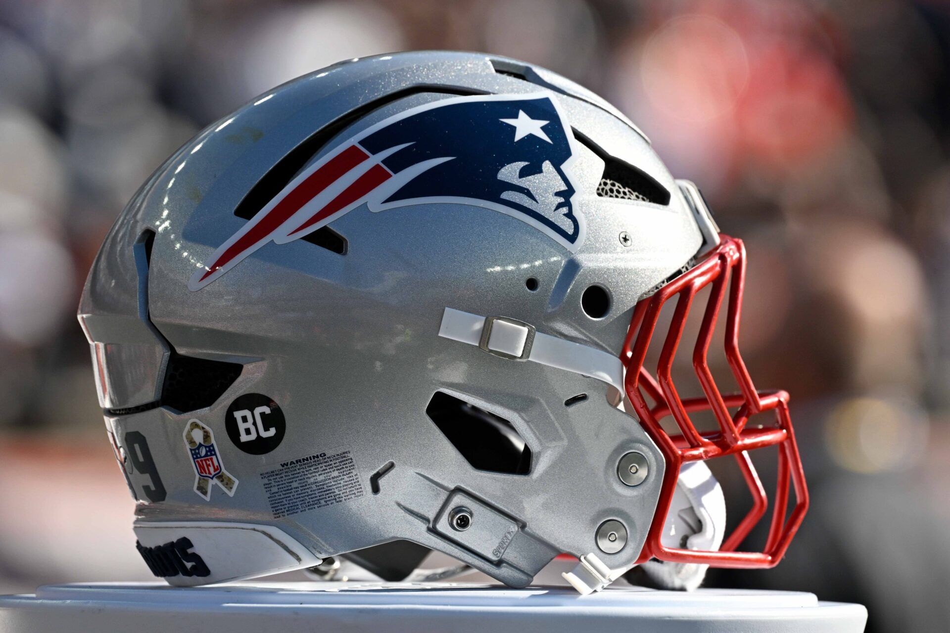A New England Patriots helmet sits on game day equipment before a game against the Atlanta Falcons at Gillette Stadium.