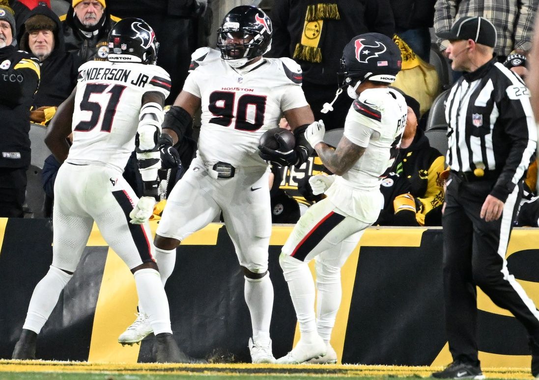 Houston Texans defensive tackle Sheldon Rankins (90) celebrates with Houston Texans defensive end Will Anderson Jr. (51) and safety Jalen Pitre (5) after returning a fumble for a touchdown during the second half of an AFC Wild Card Round game against the Pittsburgh Steelers at Acrisure Stadium.