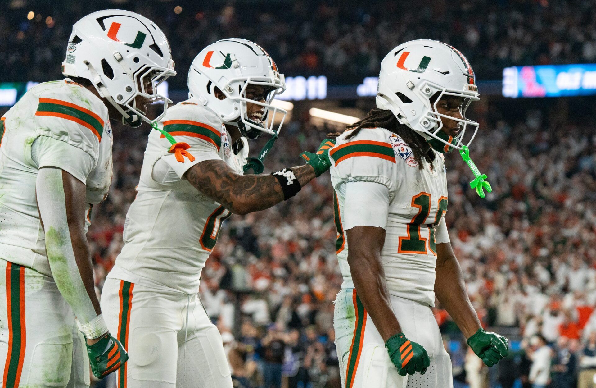 Miami Hurricanes wide receiver Keelan Marion (0) pats Malachi Toney (10) on the back after his touchdown during the CFP Fiesta Bowl at the State Farm Stadium, in Glendale, Ariz., on Thursday, Jan. 8, 2026.