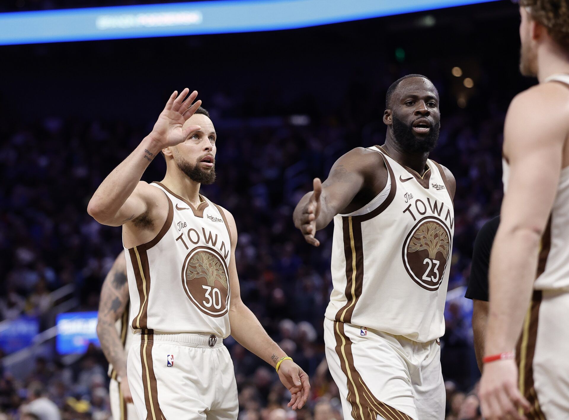 Golden State Warriors guard Stephen Curry (30) and forward Draymond Green (23) high five guard Brandin Podziemski (2) after a play against the Sacramento Kings during the fourth quarter at Chase Center.
