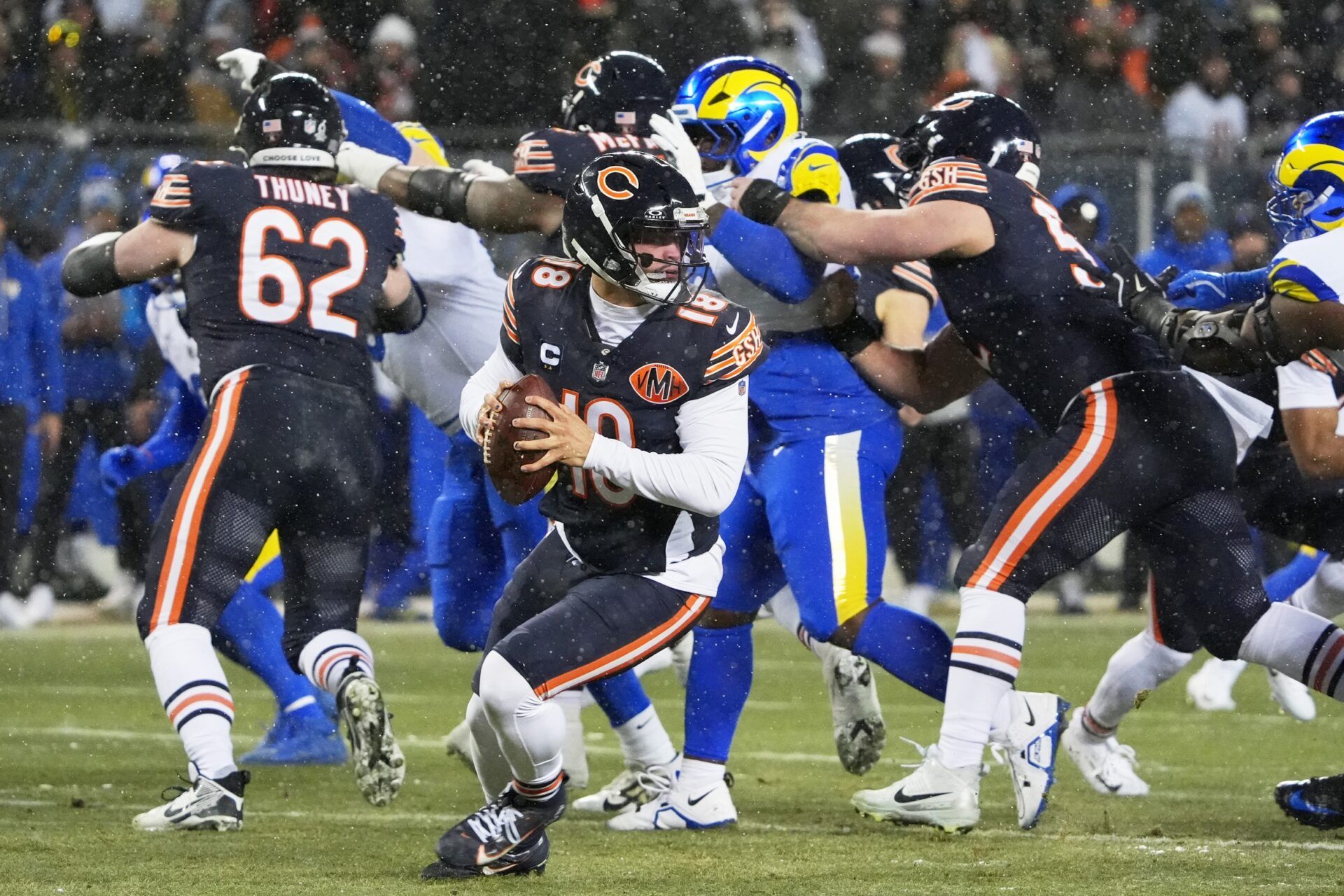 Chicago Bears quarterback Caleb Williams (18) looks to throw a pass against the Los Angeles Rams during the first quarter of an NFC Divisional Round game at Soldier Field.