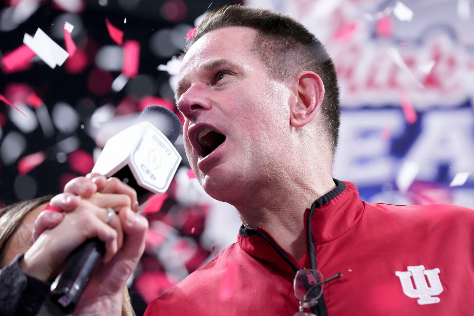 Indiana Hoosiers head coach Curt Cignetti is interviewed as confetti falls Friday, Jan. 9, 2026, after defeating the Oregon Ducks in the Peach Bowl and semifinal game of the College Football Playoff at Mercedes-Benz Stadium in Atlanta.