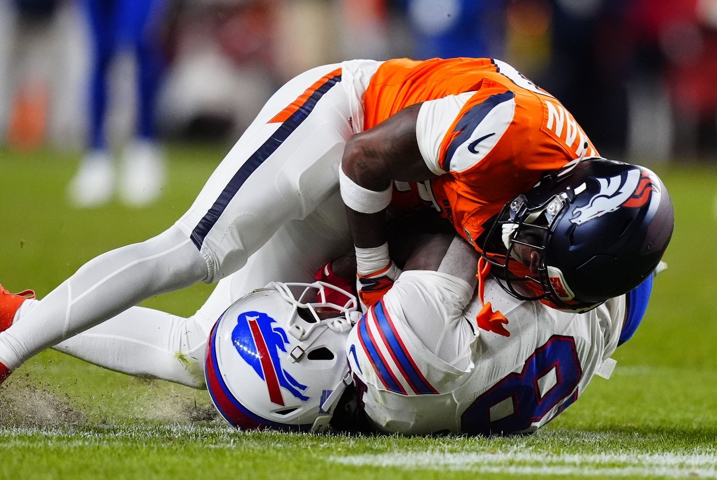 Denver Broncos cornerback Ja'quan McMillian (29) intercepts a pass intended for Buffalo Bills wide receiver Brandin Cooks (18) during overtime of an AFC Divisional Round playoff game at Empower Field at Mile High.