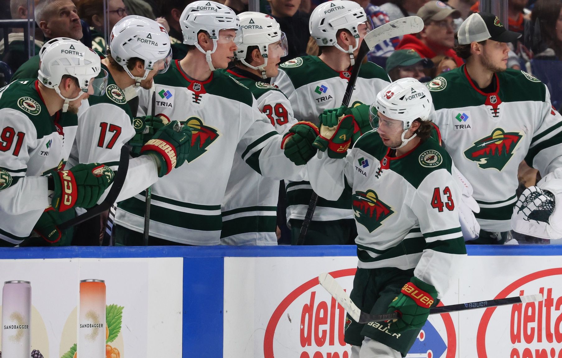 Minnesota Wild defenseman Quinn Hughes (43) celebrates his goal with teammates during the second period against the Buffalo Sabres at KeyBank Center.