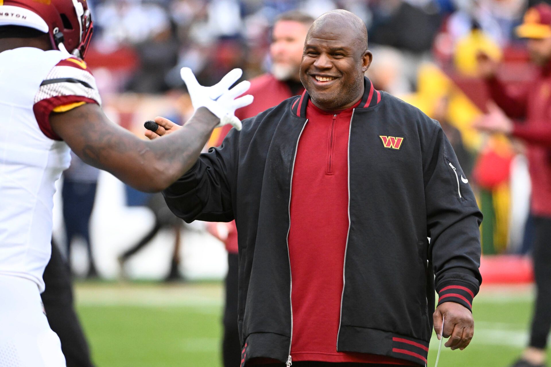 Washington Commanders offensive coordinator Eric Bieniemy on the field before the game against the Dallas Cowboys at FedExField.