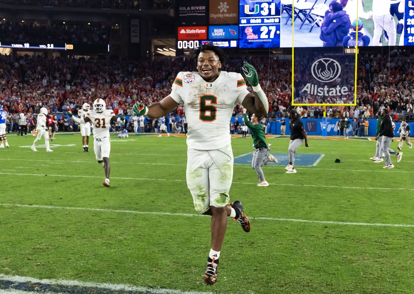 Miami Hurricanes running back CharMar Brown (6) celebrates after defeating the Mississippi Rebels during the 2026 Fiesta Bowl and semifinal game of the College Football Playoff at State Farm Stadium.