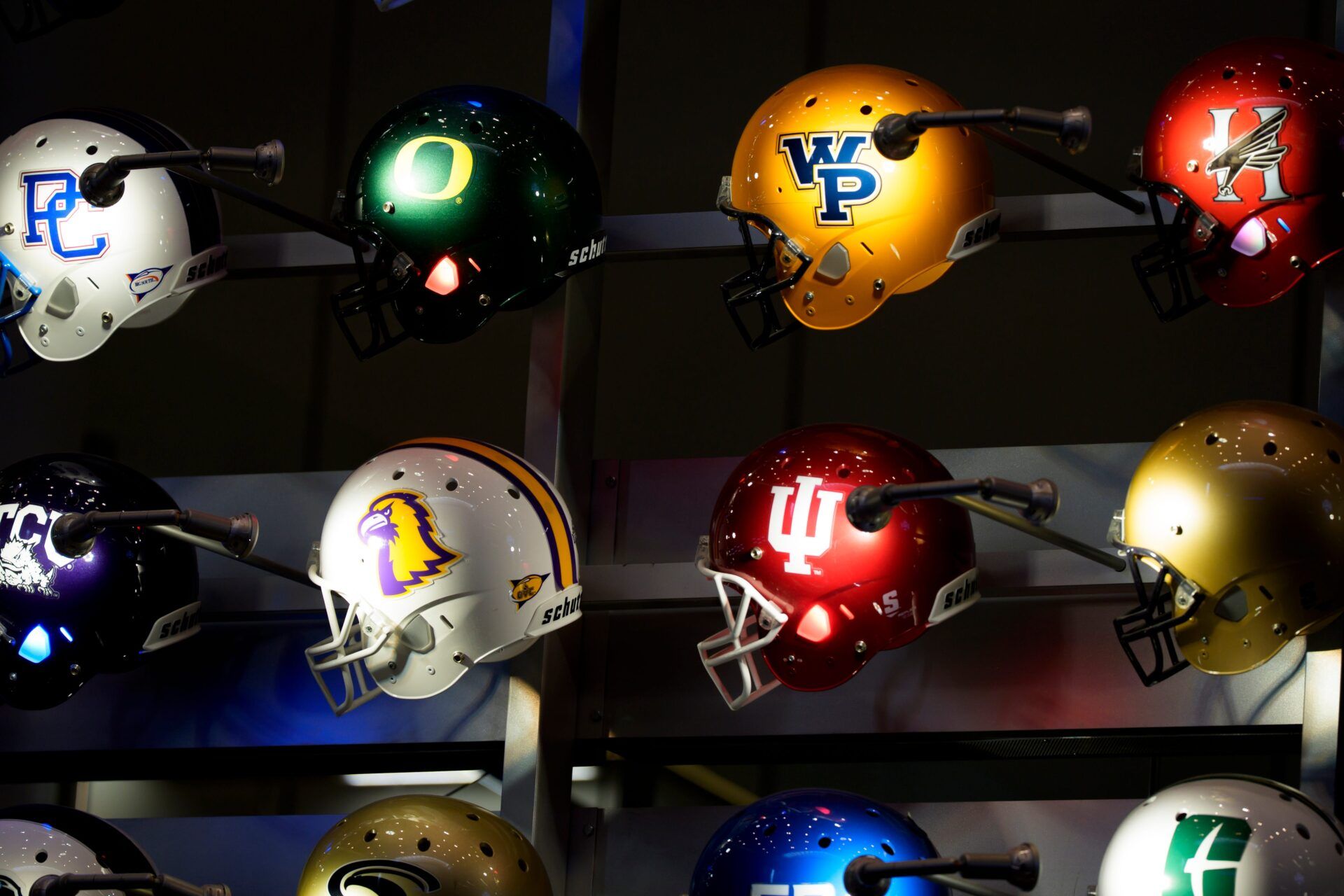 Oregon and Indiana’s helmets adorn a wall on Jan. 7, 2025, at the College Football Hall of Fame in Atlanta, Georgia, ahead of the Peach Bowl.