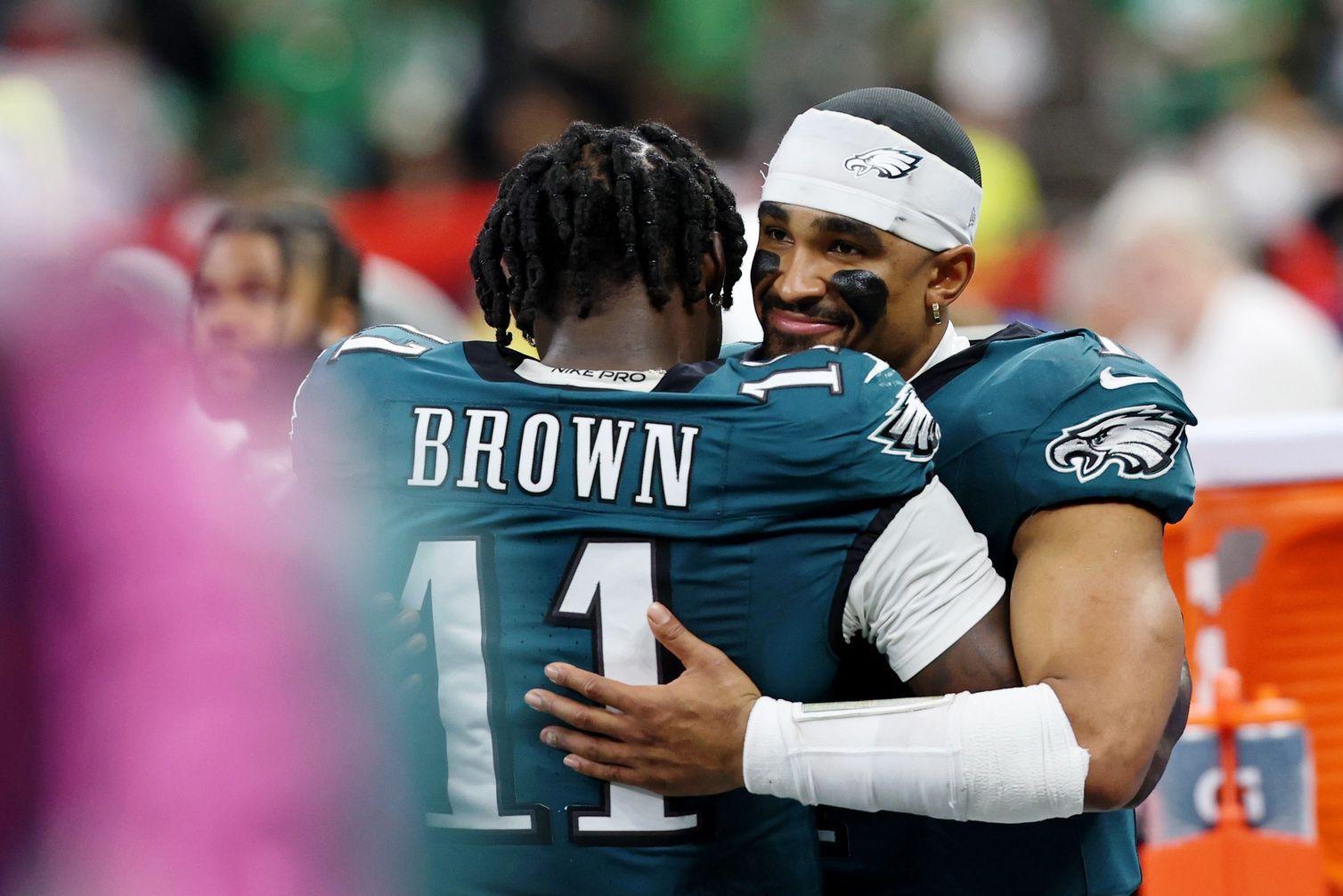 Philadelphia Eagles wide receiver A.J. Brown (11) hugs quarterback Jalen Hurts (1) during the second half of Super Bowl LIX at Caesars Superdome.