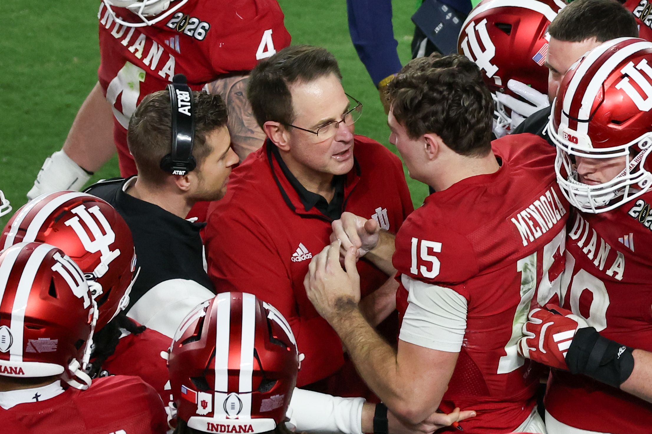 Indiana Hoosiers quarterback Fernando Mendoza (15) celebrates with head coach Curt Cignetti after scoring a touchdown against the Miami Hurricanes in the fourth quarter during the College Football Playoff National Championship game at Hard Rock Stadium.