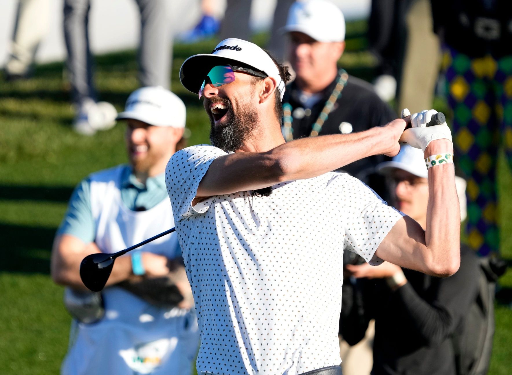 Michael Phelps laughs after hitting his first shot from the 10th tee box during the Annexus Pro-AM at TPC in Scottsdale.