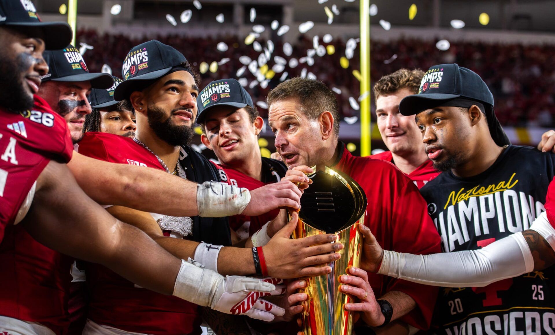 Indiana Head Coach Curt Cignetti talks with his team as they grab the trophy after the College Football Playoff National Championship college football game at Hard Rock Stadium in Miami Gardens on Monday, Jan. 19, 2026.
