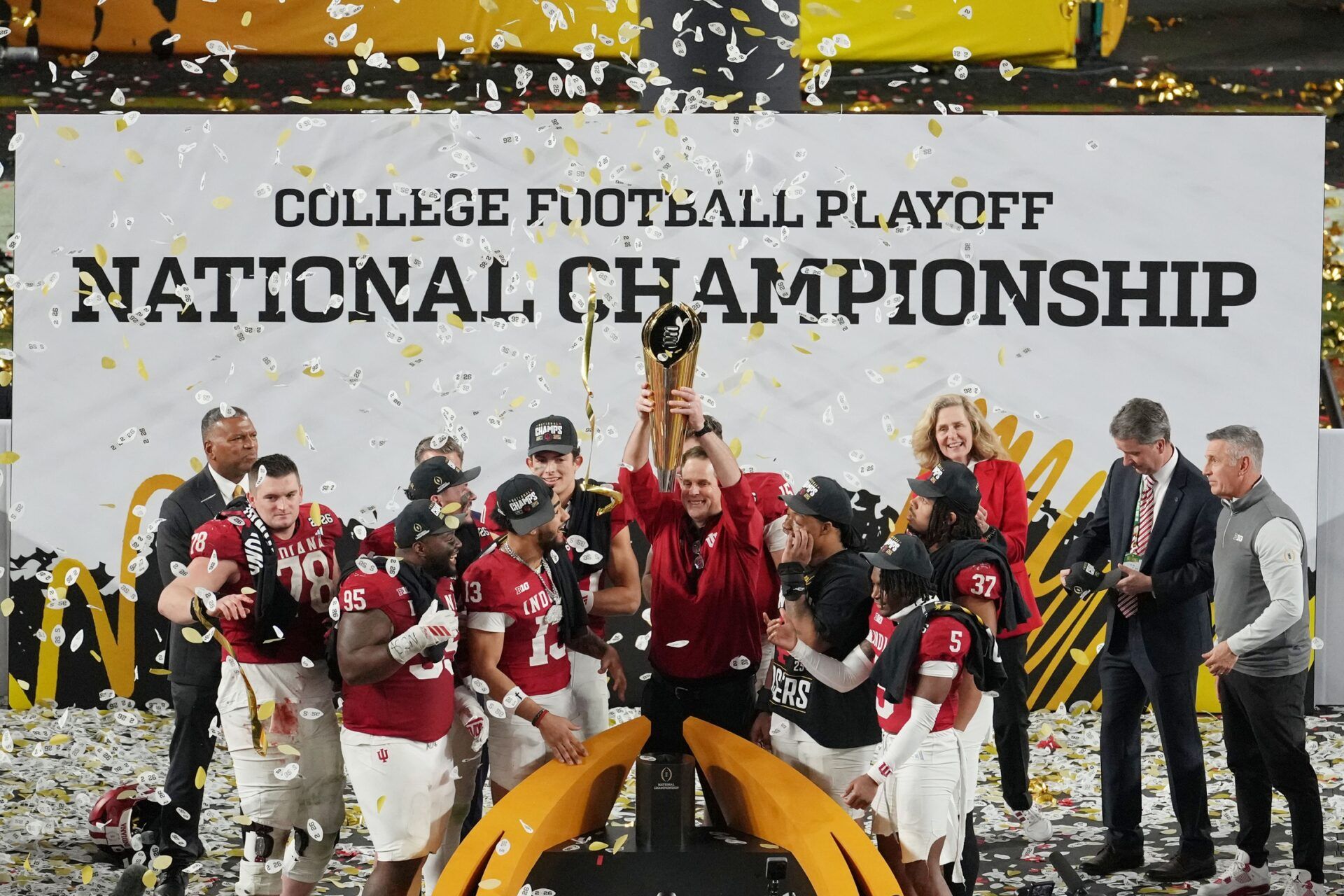 Indiana Hoosiers head coach Curt Cignetti holds up the trophy as the team celebrates winning the College Football Playoff National Championship game at Hard Rock Stadium.