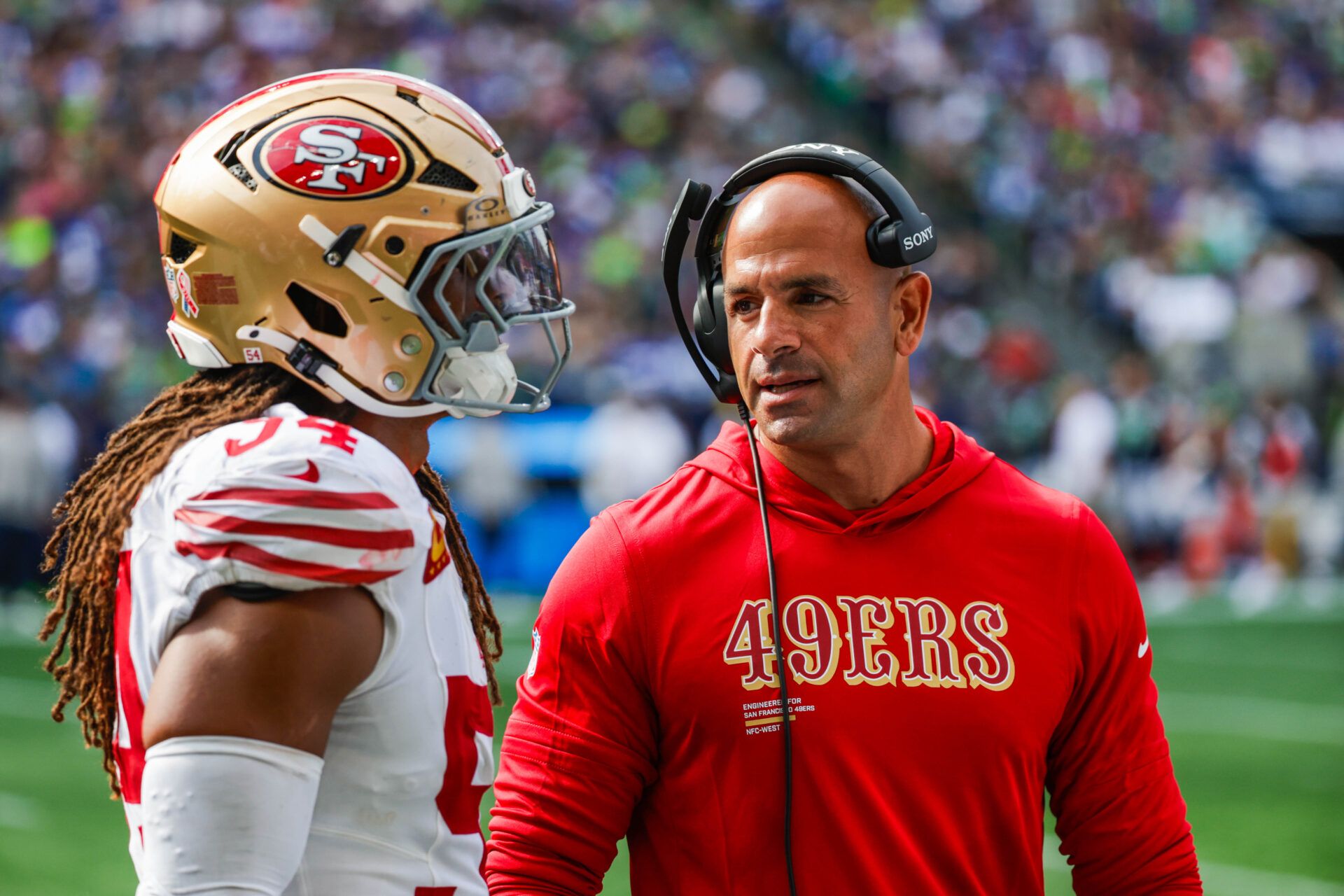 San Francisco 49ers defensive coordinator Robert Saleh talks with linebacker Fred Warner (54) during the fourth quarter against the Seattle Seahawks at Lumen Field.