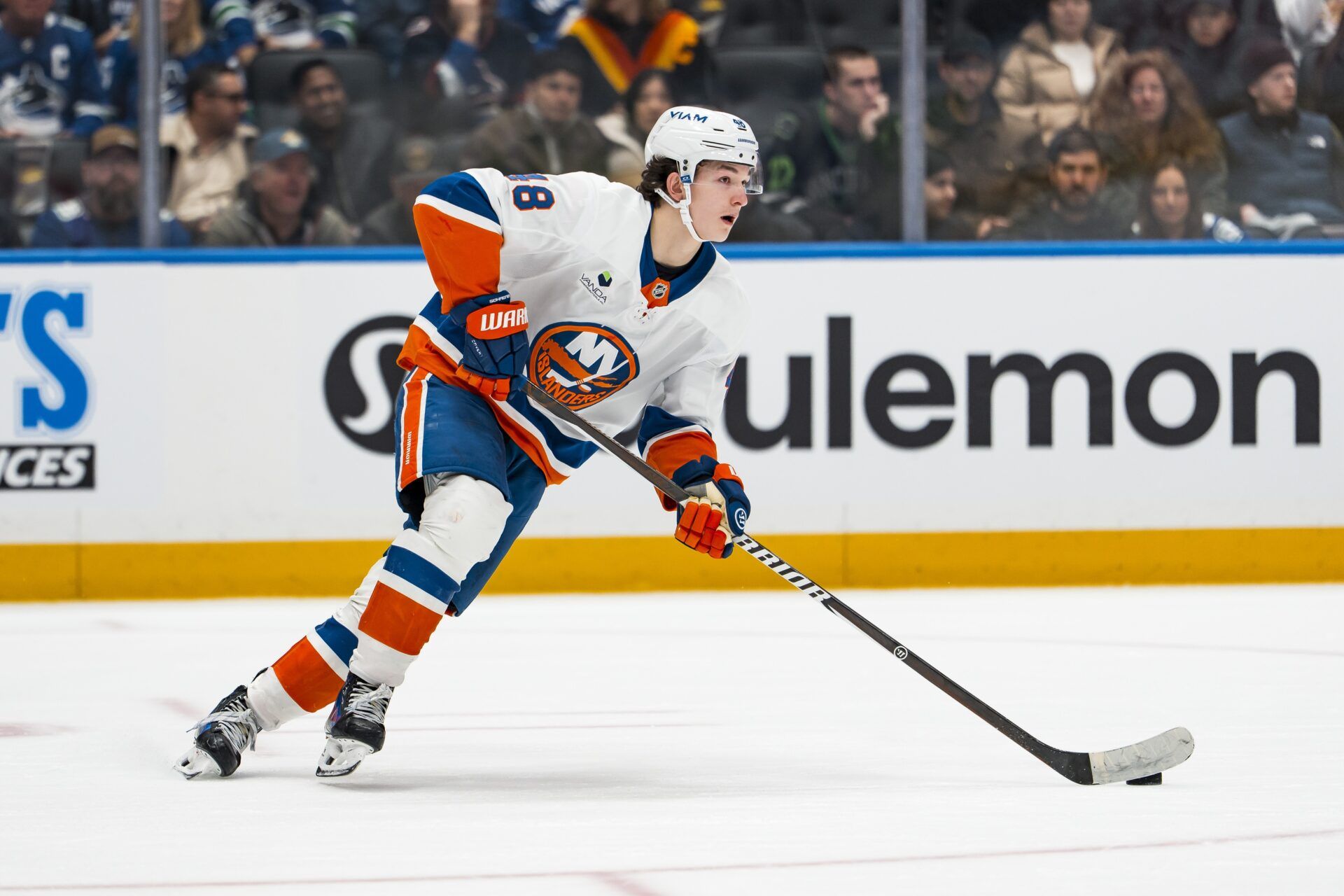 New York Islanders defenseman Matthew Schaefer (48) plays the puck against the Vancouver Canucks in the second period at Rogers Arena.