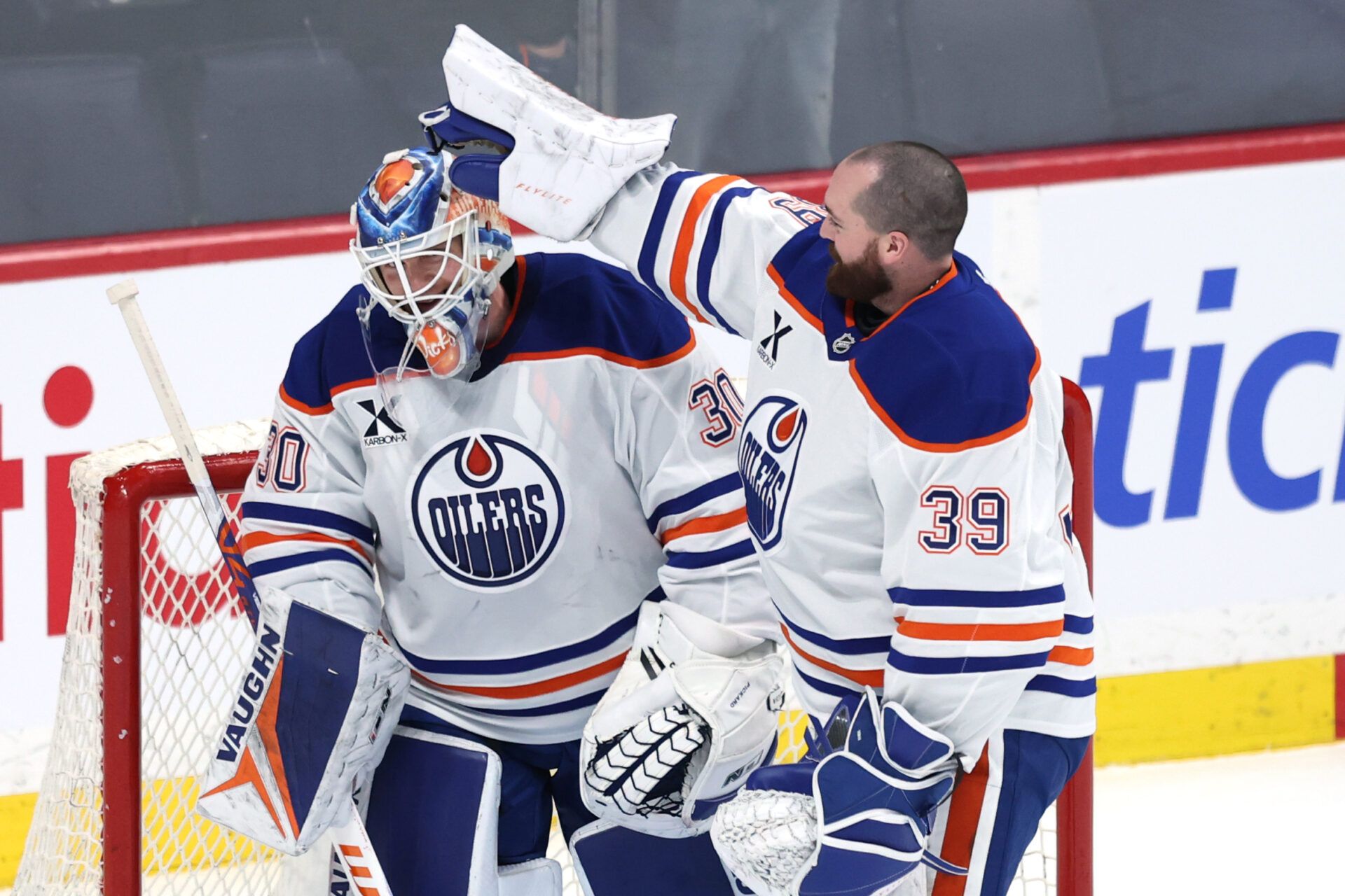 Edmonton Oilers goaltender Calvin Pickard (30) and Edmonton Oilers goaltender Connor Ingram (39) celebrate their victory over the Winnipeg Jets at Canada Life Centre.