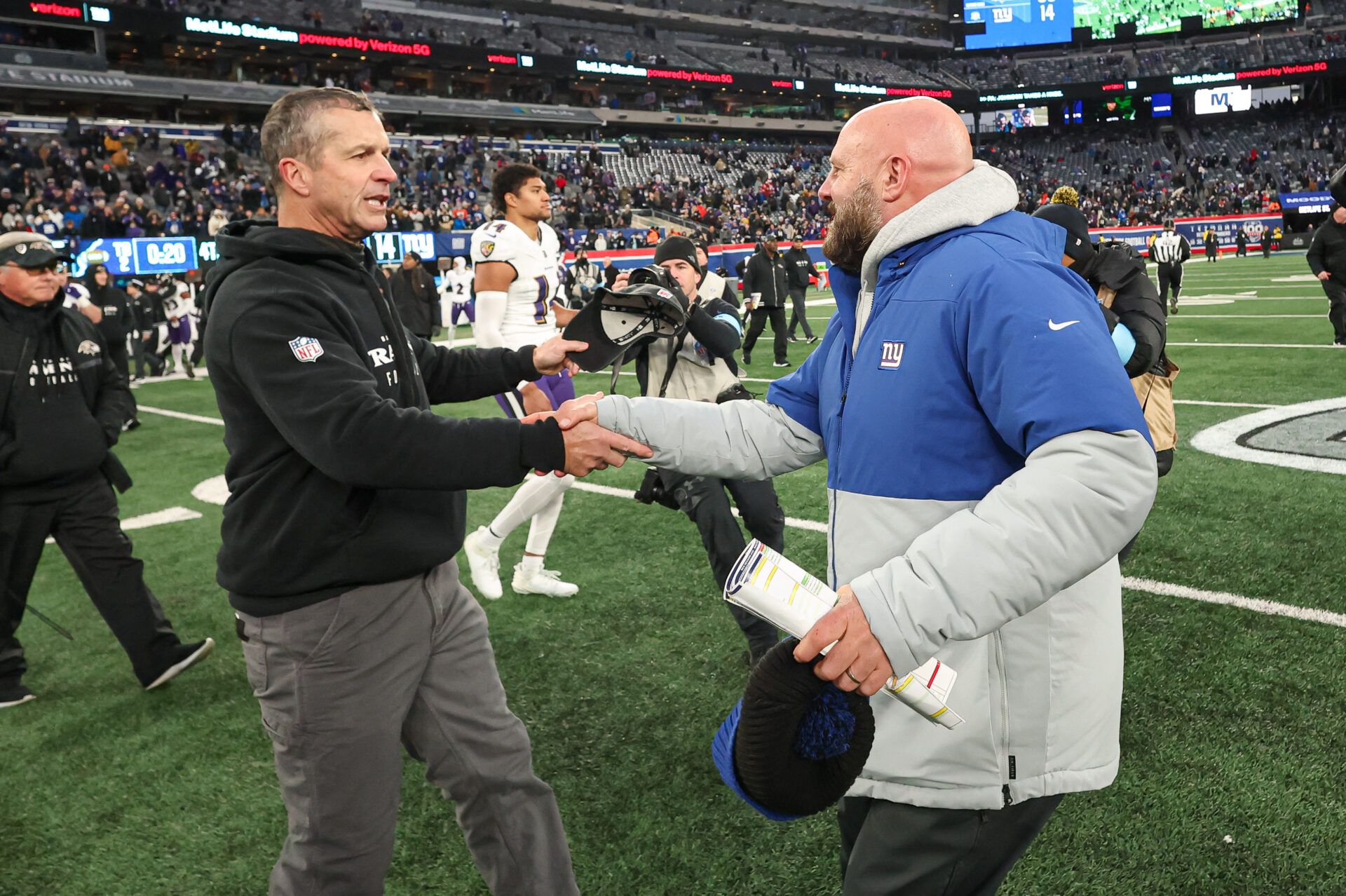 Baltimore Ravens head coach John Harbaugh, left, shakes hands with New York Giants head coach Brian Daboll  after the game at MetLife Stadium.