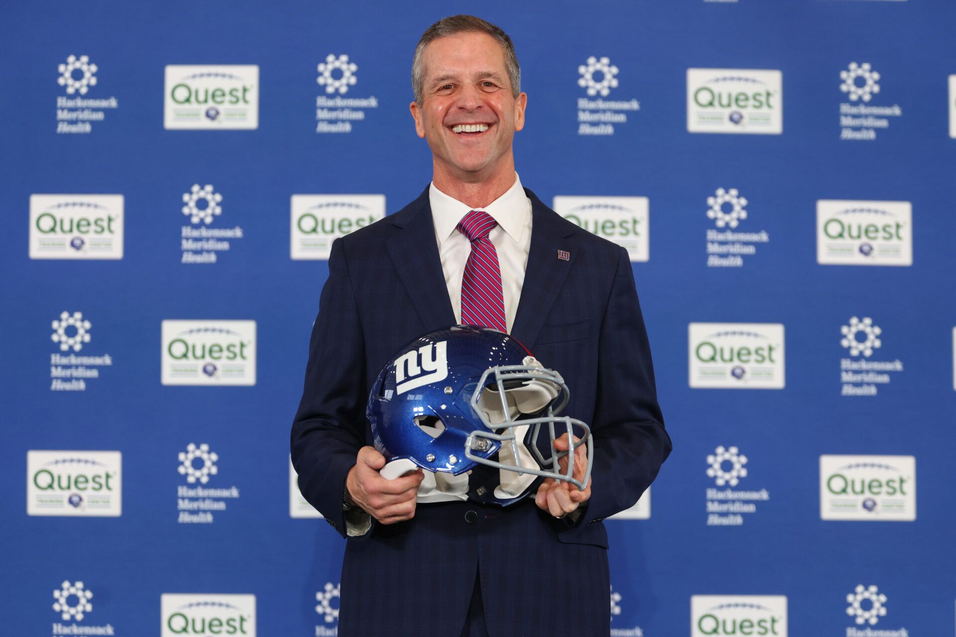 John Harbaugh poses after the press conference announcing his hiring as the next New York Giants head coach at Quest Diagnostics Training Center.
