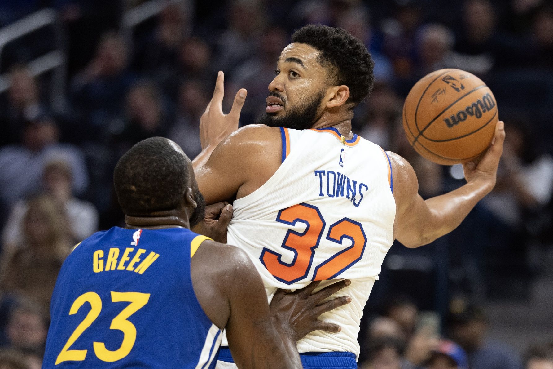 New York Knicks center Karl-Anthony Towns (32) has the ball defended by Golden State Warriors forward Draymond Green (23) during the second quarter at Chase Center.