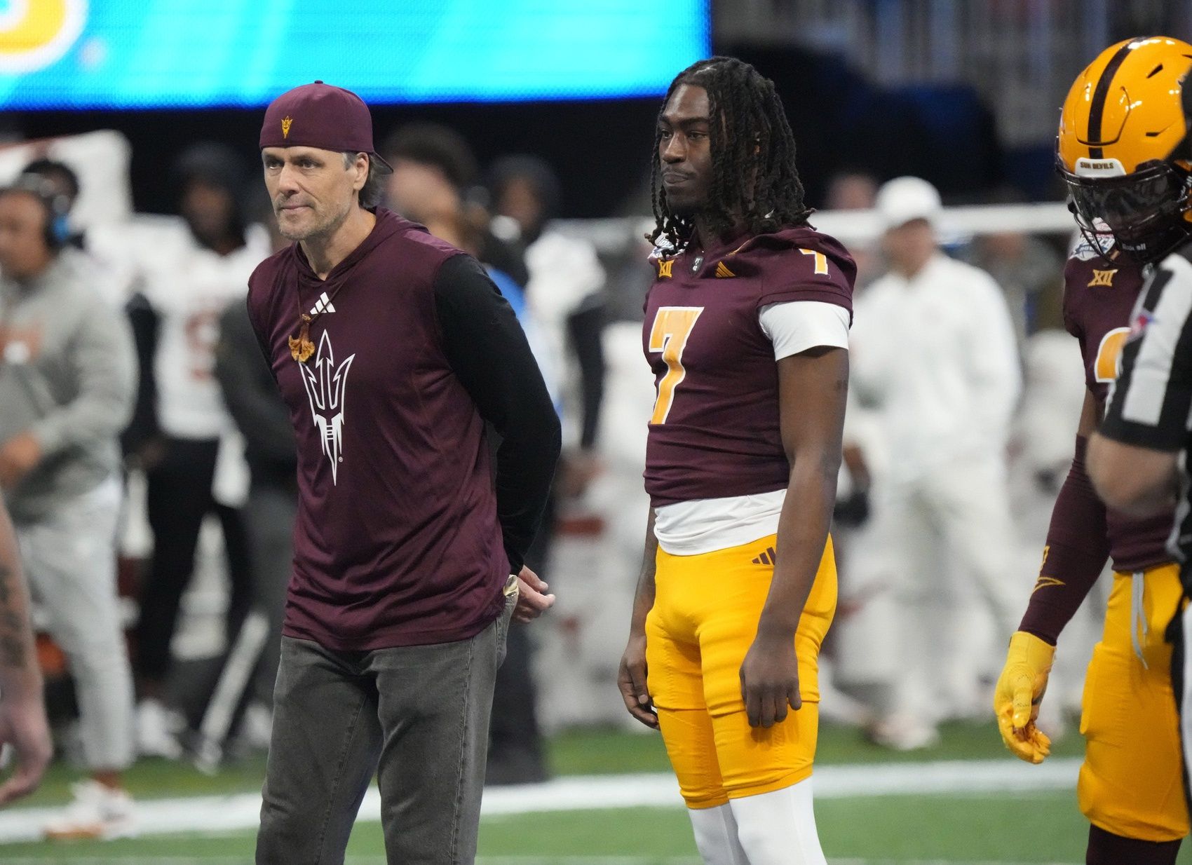 Former Arizona State quarterback Jake Plummer walks out with players for the coin toss against Texas in the Chick-fil-A Peach Bowl in Atlanta on Jan. 1, 2025.