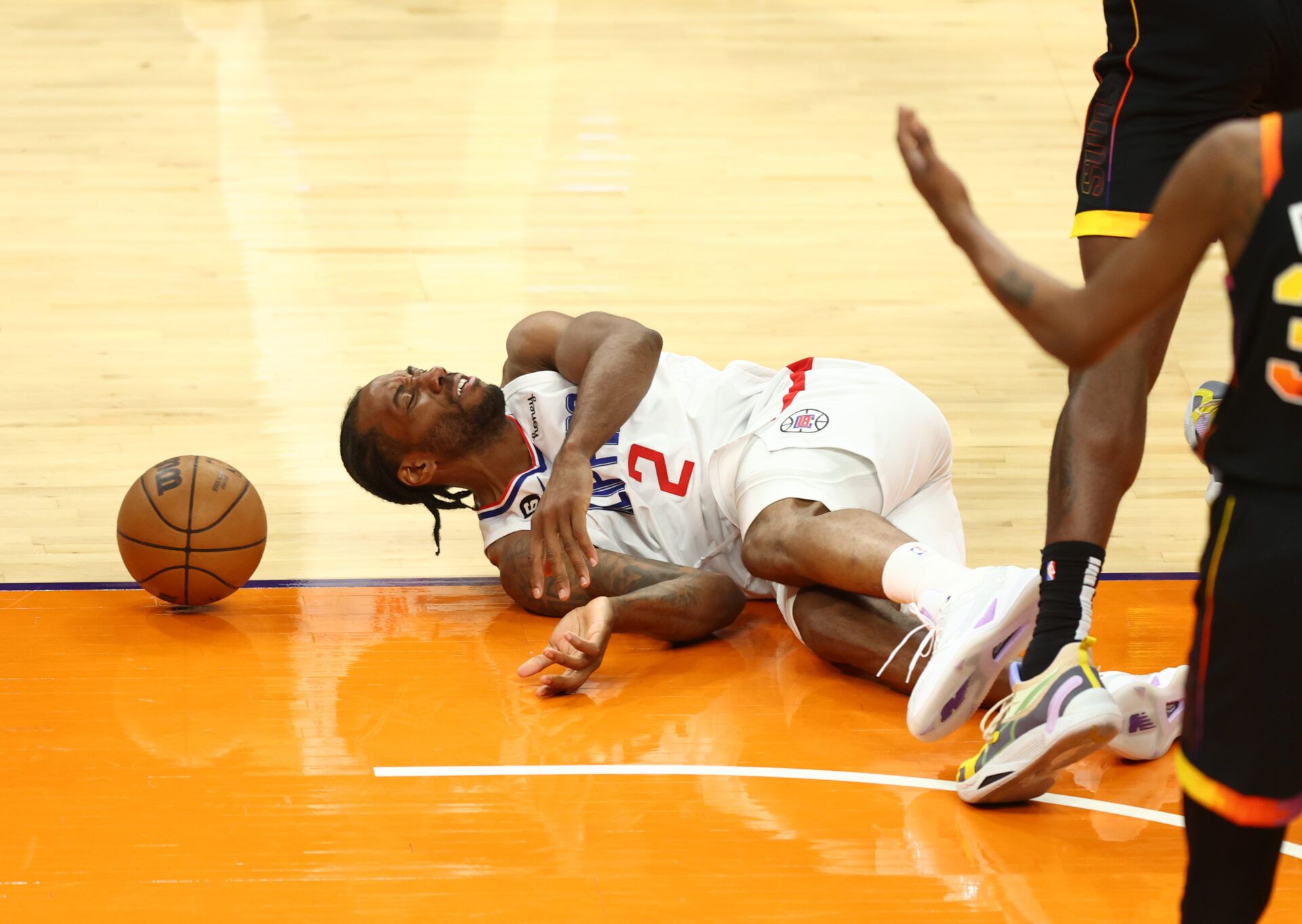 Los Angeles Clippers forward Kawhi Leonard (2) reacts after suffering an injury against the Phoenix Suns during game two of the 2023 NBA playoffs at Footprint Center.