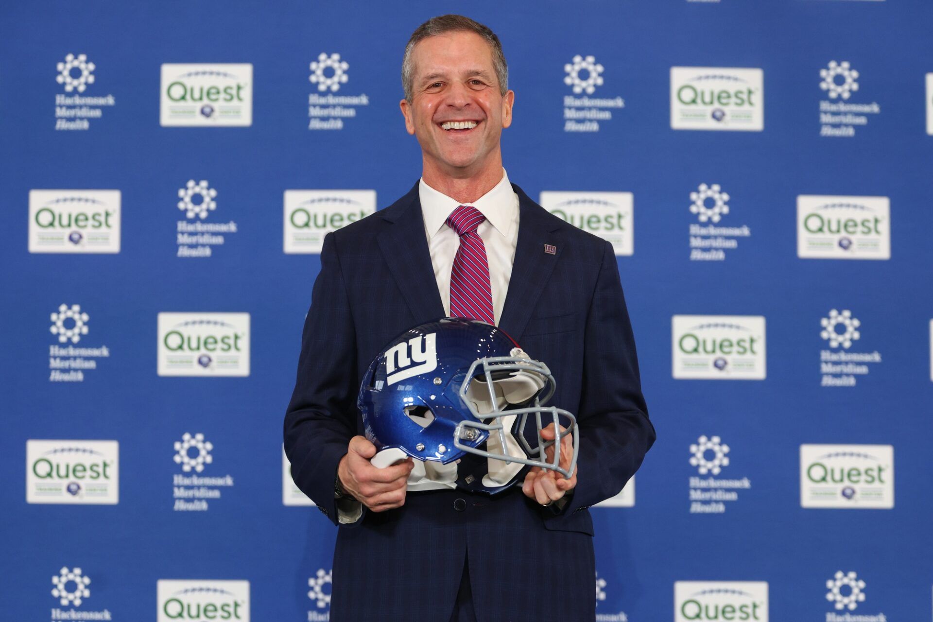 John Harbaugh poses after the press conference announcing his hiring as the next New York Giants head coach at Quest Diagnostics Training Center.