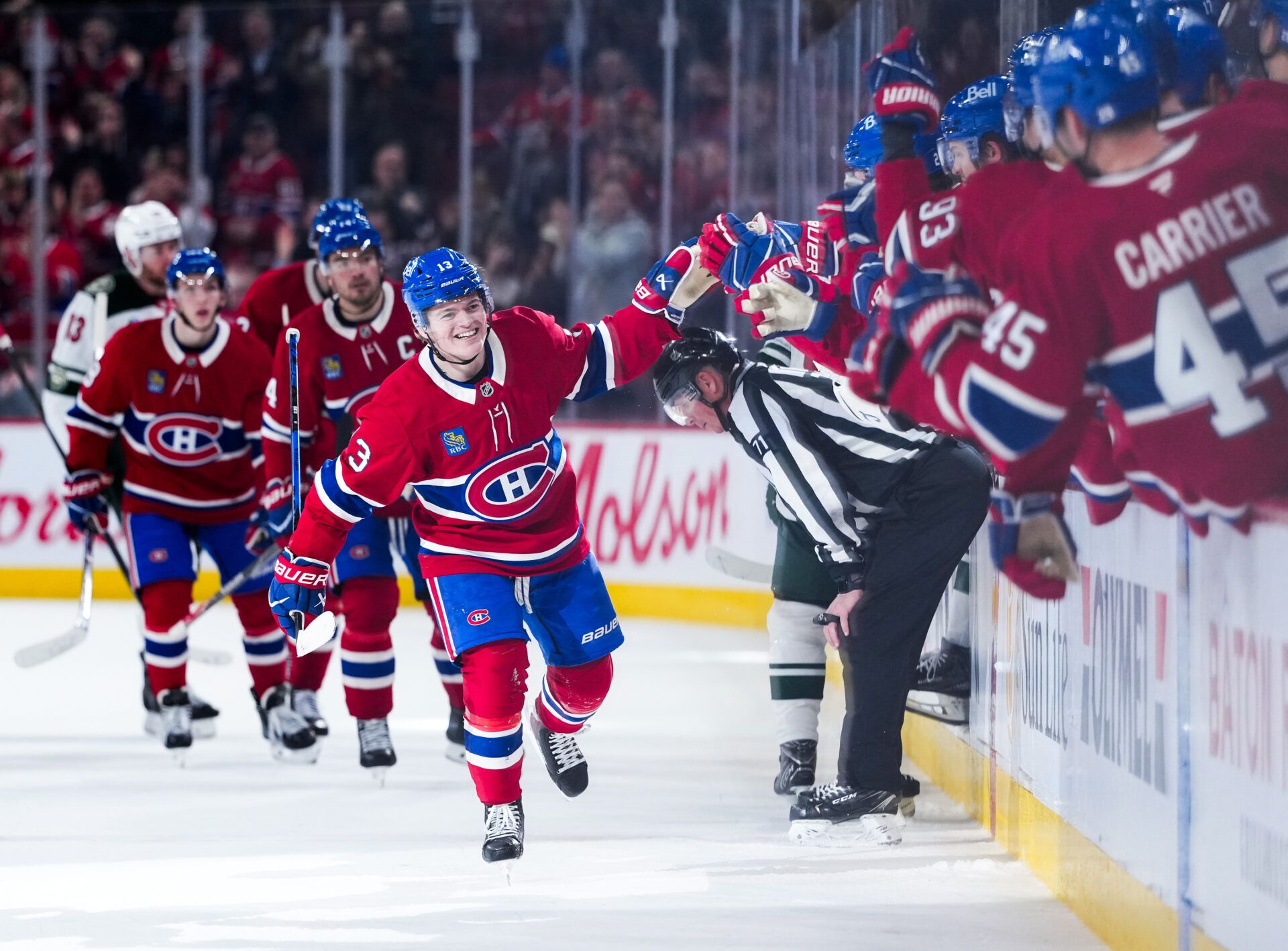 Montreal Canadiens forward Cole Caufield (13) celebrates with teammates after scoring a goal against the Minnesota Wild during the third period at the Bell Centre.