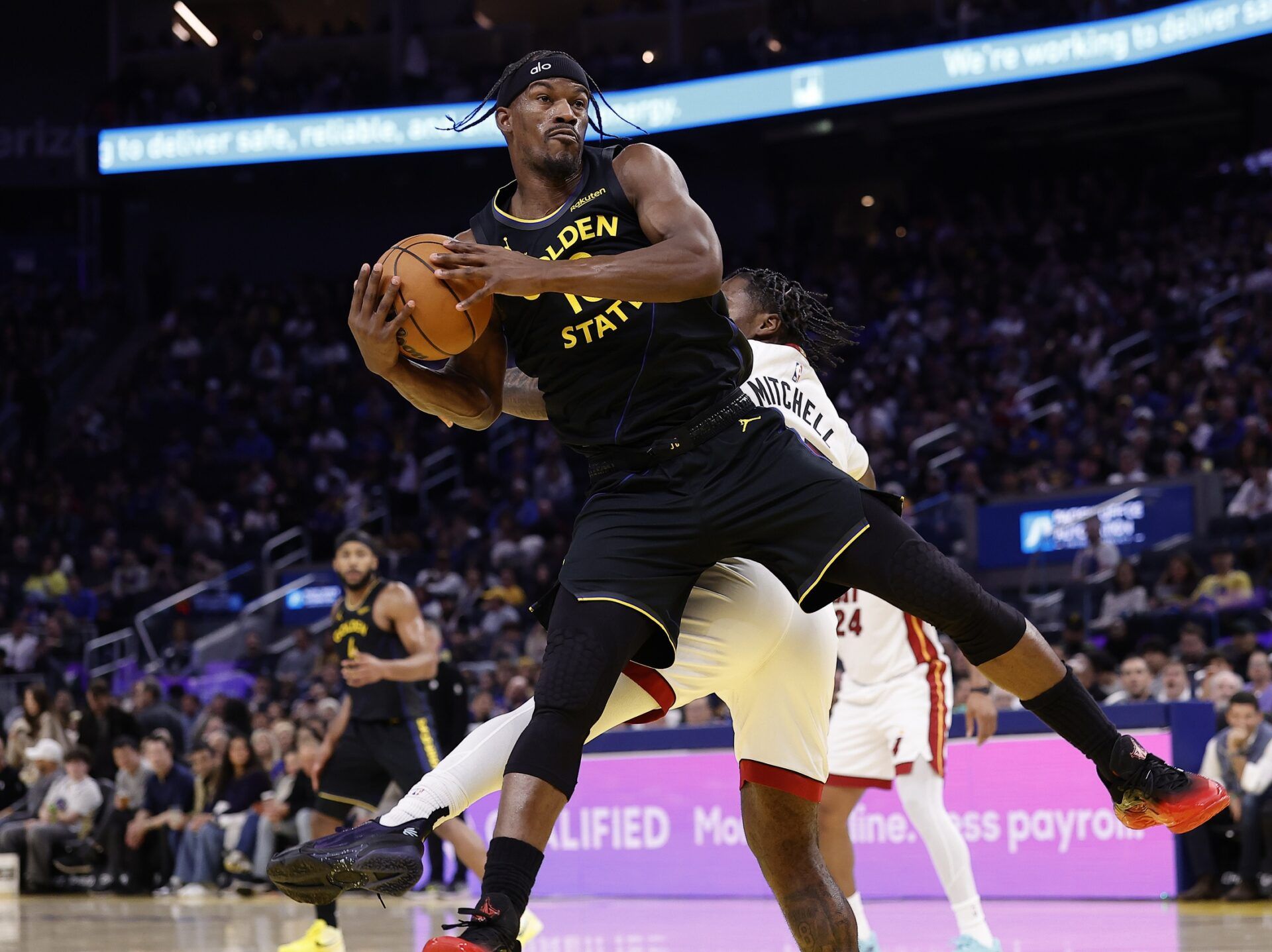 Golden State Warriors forward Jimmy Butler III (10) on a play against Miami Heat guard Davion Mitchell (45) resulting in a knee injury during the third quarter at Chase Center.