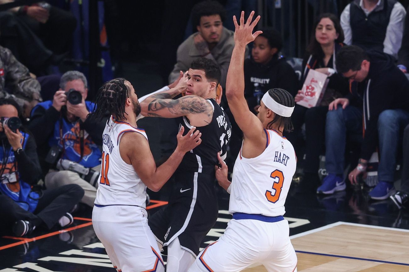 Brooklyn Nets forward Michael Porter Jr. (17) is double teammed by New York Knicks guards Jalen Brunson (11) and Josh Hart (3) in the first quarter at Madison Square Garden.