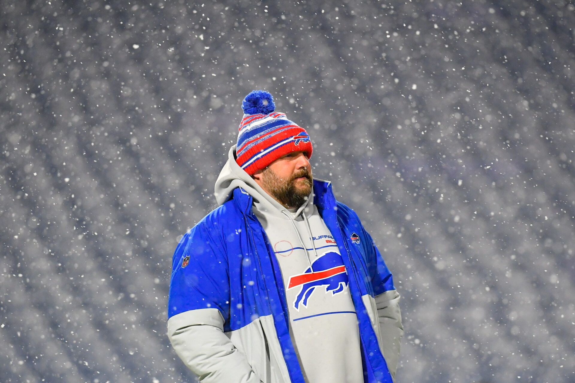 Buffalo Bills offensive coordinator Brian Daboll looks on during a snow storm prior to the game against the New England Patriots at Highmark Stadium.