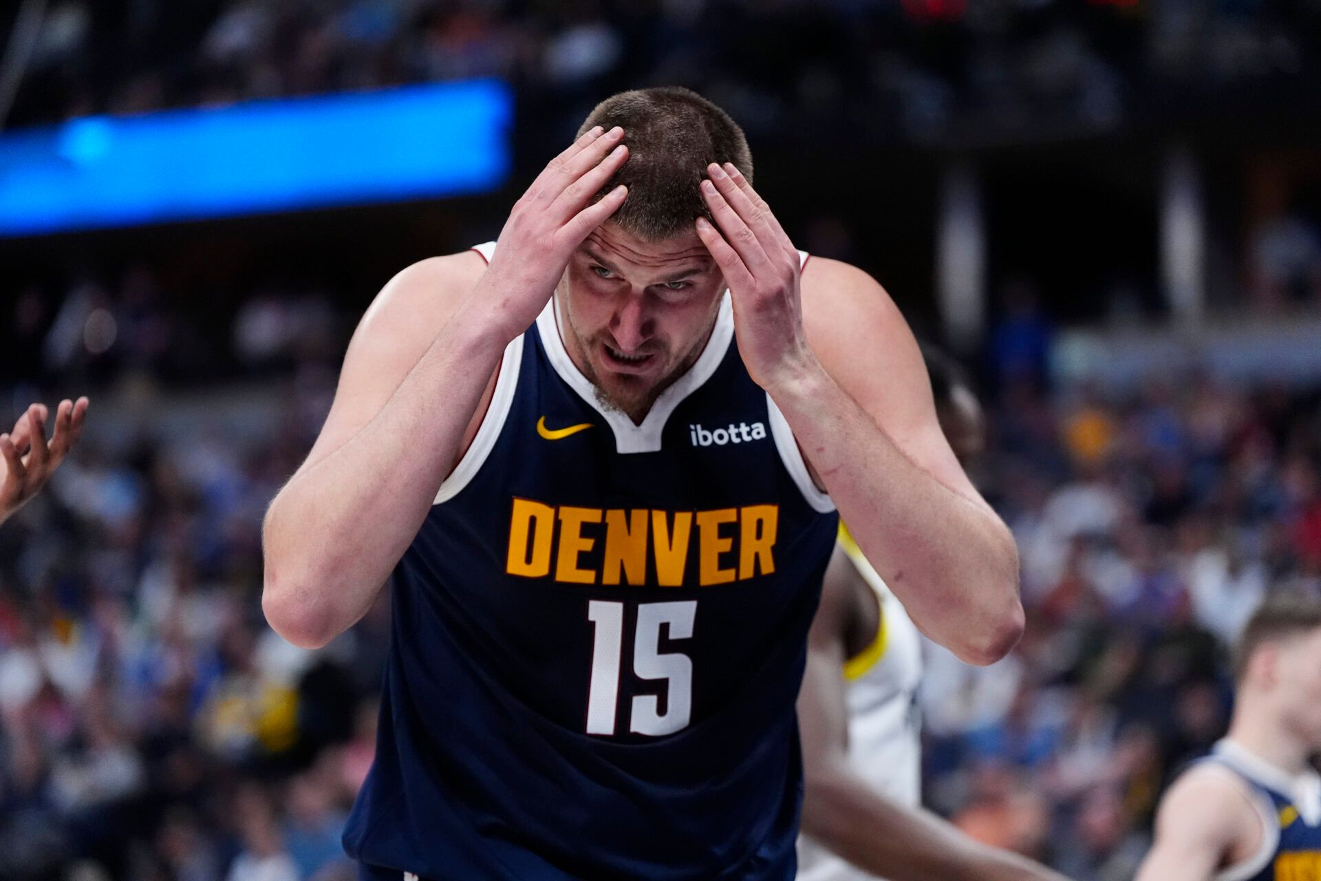 Denver Nuggets center Nikola Jokic (15) reacts after a head injury in the second quarter against the Utah Jazz at Ball Arena.