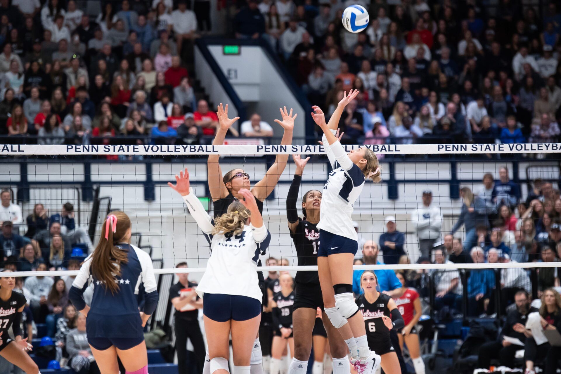 Penn State's Izzy Starck, right, jumps up to set the ball during a Big Ten volleyball match against Nebraska at Rec Hall on Friday, Nov. 29, 2024, in State College, Pa.