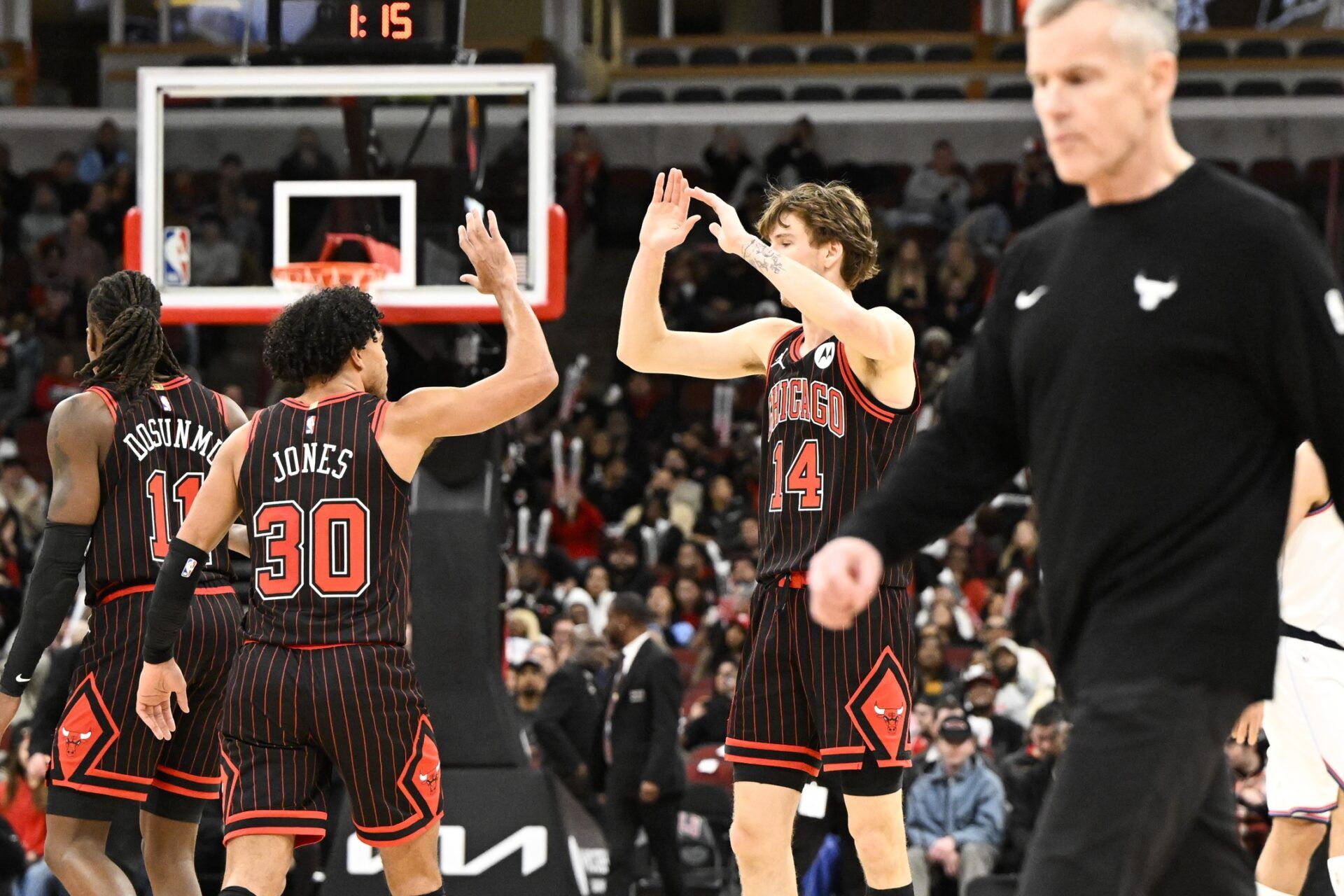 Chicago Bulls forward Matas Buzelis (14) and  guard Tre Jones (30) high five during the second half against the LA Clippers at United Center.