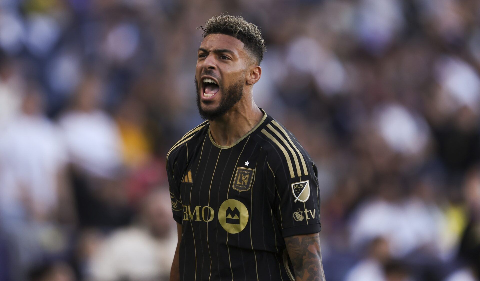 Los Angeles FC forward Denis Bouanga (99) reacts after scoring a goal during the first half of a soccer game against the Los Angeles Galaxy at Dignity Health Sports Park.