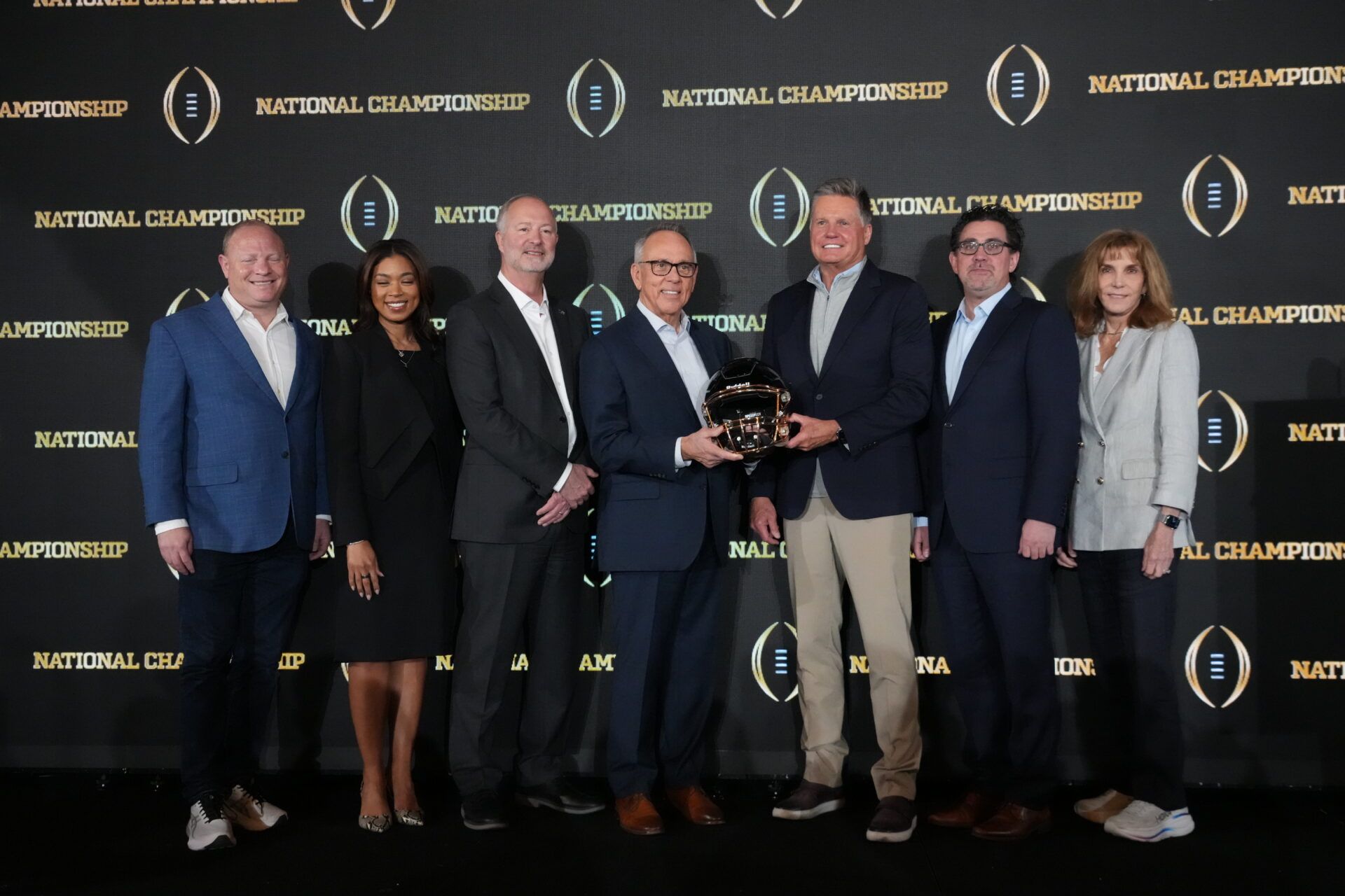 Las Vegas 2027 host committee members (from left) Andy Gorchav, Sandra Douglass Morgan, Steve Hill, Jim Gibson, Rob Dondero, Jeremy Aguero and Virginia Valentine pose during the CFP host committee handoff press conference at Marriott Marquis Miami.