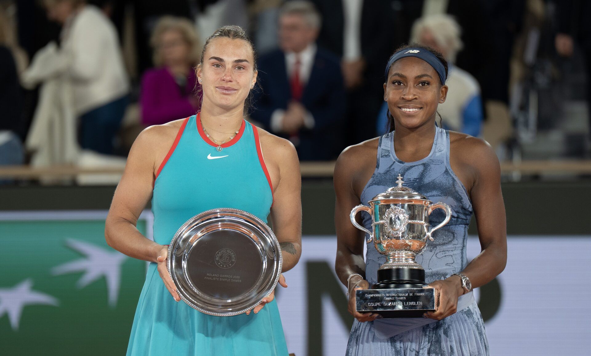 Coco Gauff of the United States poses with Aryna Sabalenka after their match on day 14 at Roland Garros Stadium.