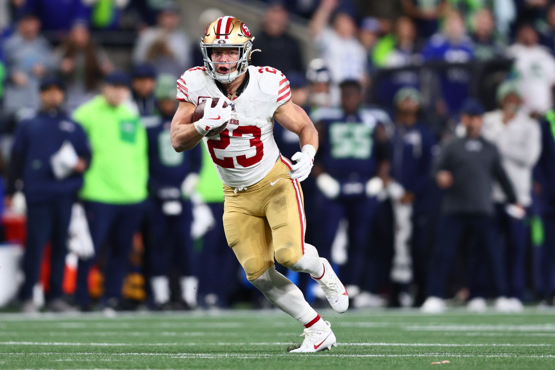 San Francisco 49ers running back Christian McCaffrey (23) runs after the catch against the Seattle Seahawks during the first half in an NFC Divisional Round game at Lumen Field.