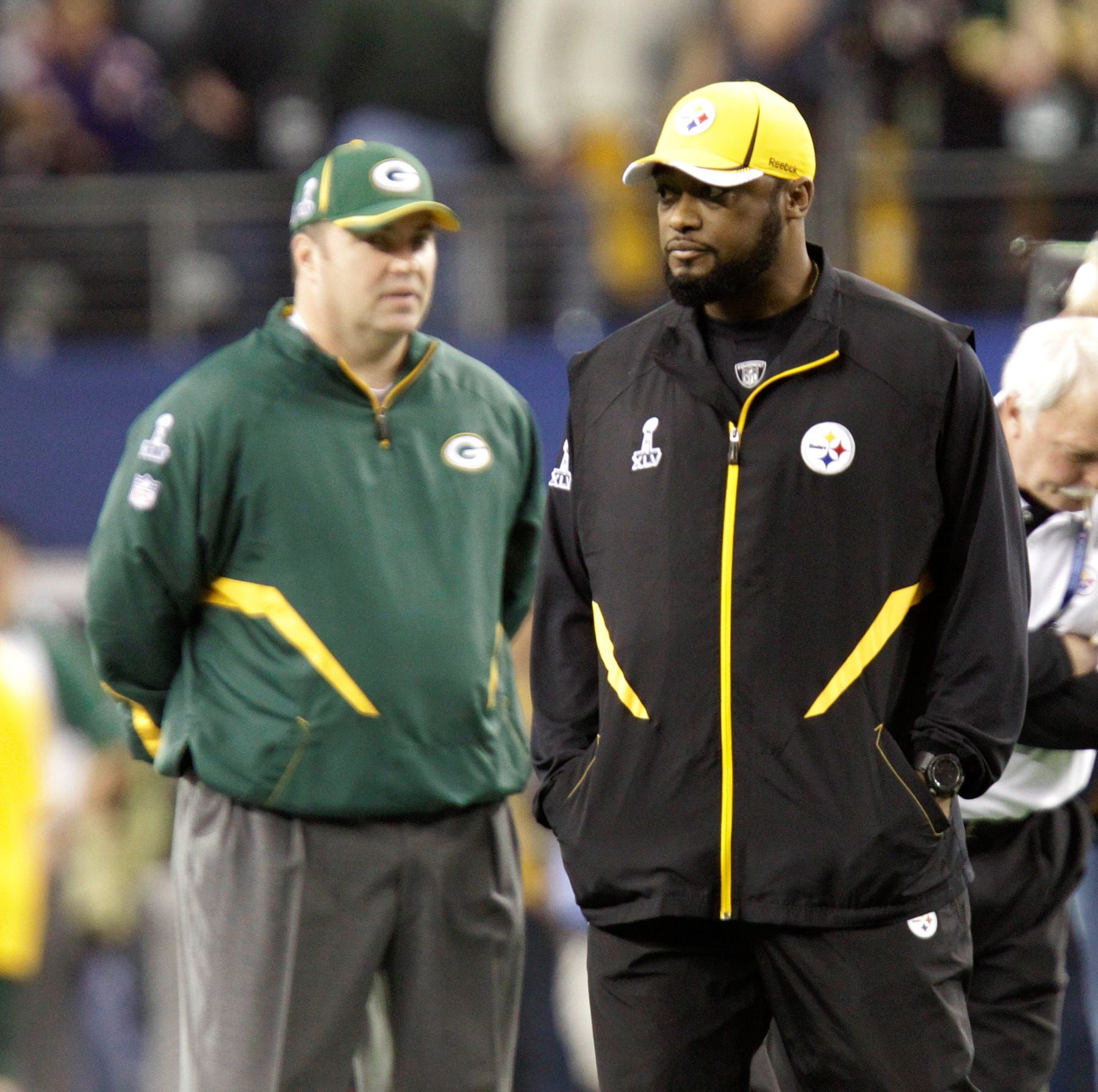 The Green Bay Packers head coach Mike McCarthy, left, looks at Pittsburgh Steelers head coach Mike Tomlin, right, prior to Super Bowl XLV, in Arlington, Texas, Sunday, February 6, 2011.