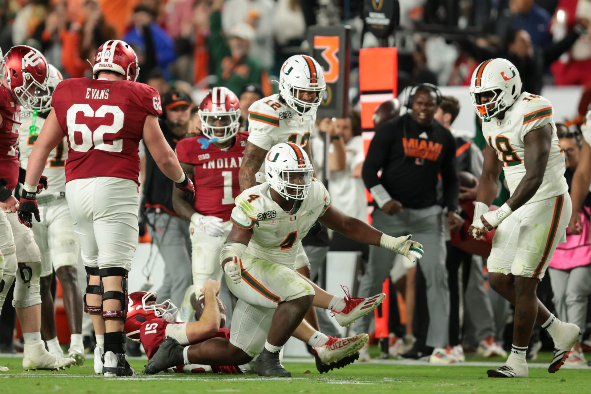 Miami Hurricanes defensive lineman Rueben Bain Jr. (4) celebrates after a sack of Indiana Hoosiers quarterback Fernando Mendoza (15) in the third quarter during the College Football Playoff National Championship game at Hard Rock Stadium.