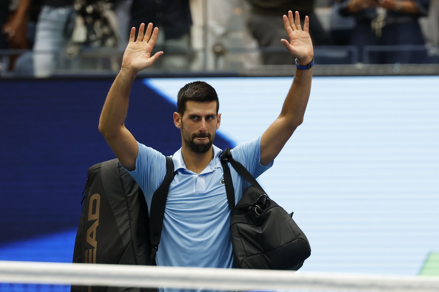 Novak Djokovic (SRB) waves to the crowd while leaving the court after his match against Carlos Alcaraz (ESP) (not pictured) after in a men's singles semifinal on day thirteen of the 2025 US Open tennis championships at USTA Billie Jean King National Tennis Center.