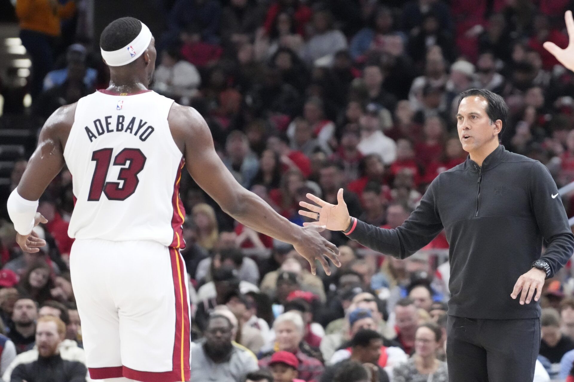 Miami Heat head coach Erik Spoelstra shakes hands with center Bam Adebayo (13) during the first quarter at United Center.