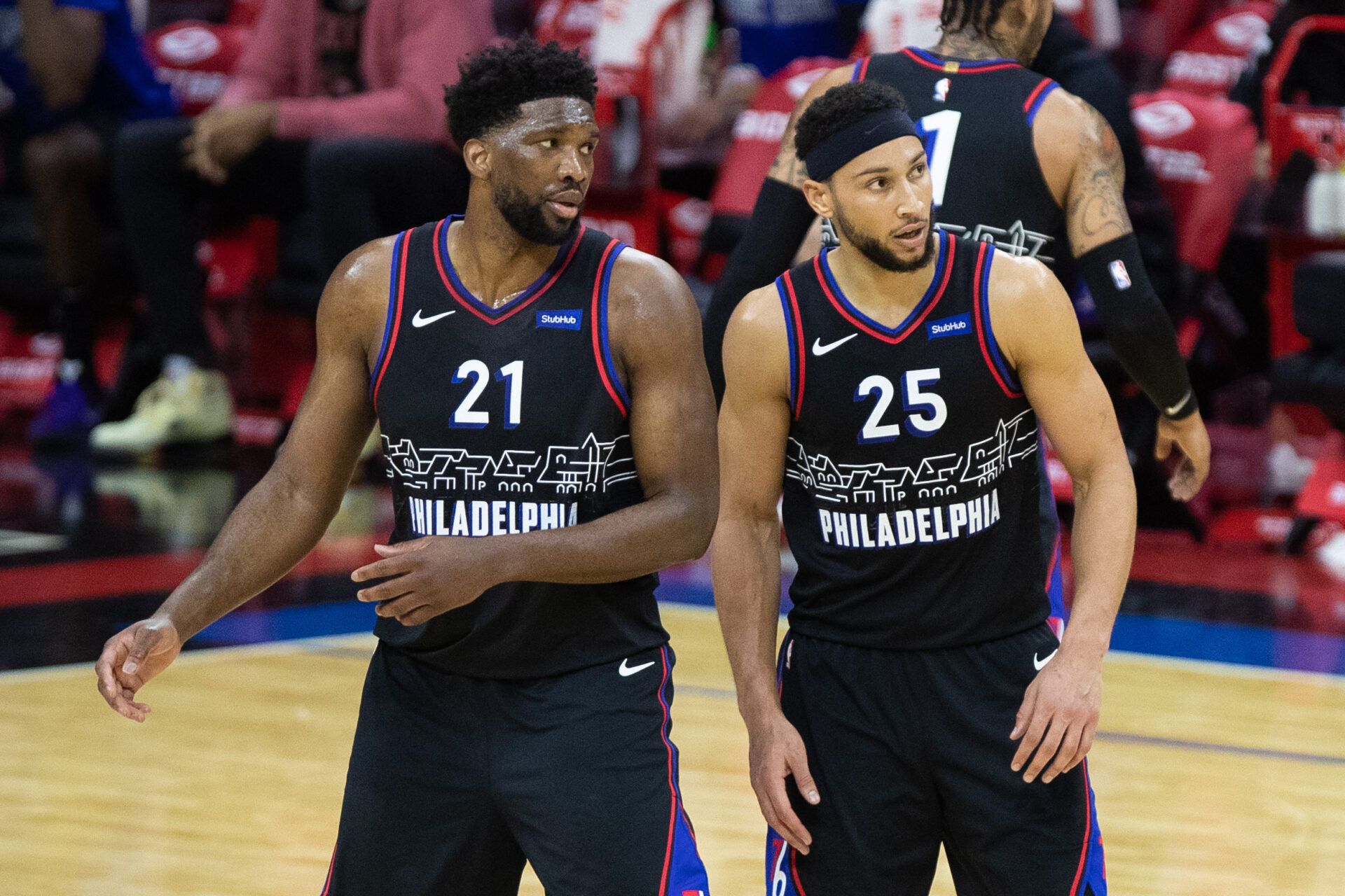 Philadelphia 76ers guard Ben Simmons (25) and center Joel Embiid (21) look on during the third quarter against the Cleveland Cavaliers at Wells Fargo Center.