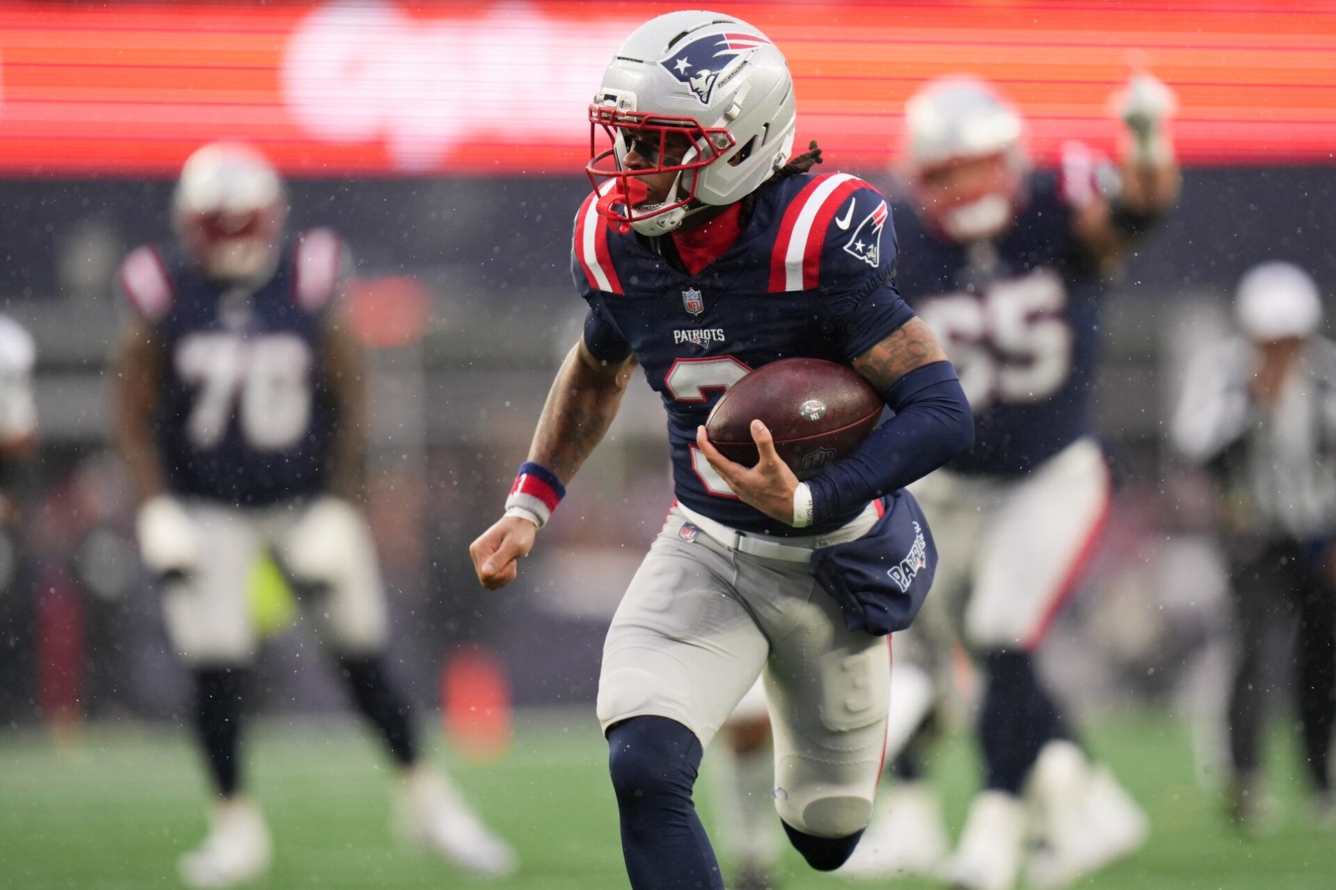 New England Patriots wide receiver DeMario Douglas (3) runs for a touchdown after a catch in the first quarter in an AFC Divisional Round game against the Houston Texans at Gillette Stadium.
