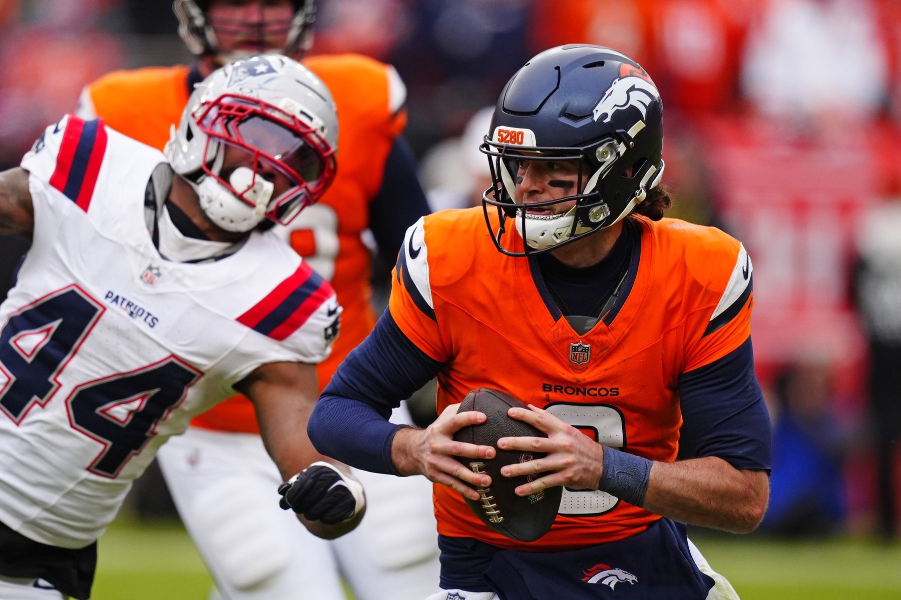 Denver Broncos quarterback Jarrett Stidham (8) drops back to pass against the New England Patriots during the first half in the 2026 AFC Championship Game at Empower Field at Mile High.