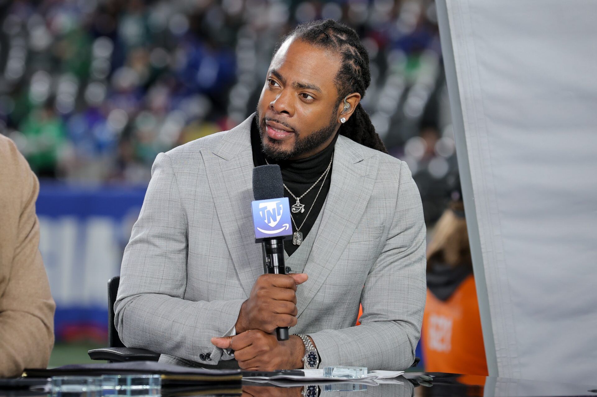 Richard Sherman is seen on the Thursday Night Football set before the game between the New York Giants and the Philadelphia Eagles at MetLife Stadium.